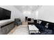 Spacious living room featuring vaulted ceilings, sleek hardwood floors, and a modern black velvet sofa at 1575 Shinnville Rd, Cleveland, NC 27013