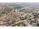 Expansive aerial view of a residential area with mature trees, well-maintained homes, and winding roads at 1601 South Point Rd, Belmont, NC 28012