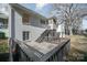 Two story home with a deck, stairs, and white painted brick at 1601 South Point Rd, Belmont, NC 28012