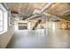 Spacious unfinished basement with a garage door entry and open ceiling at 1601 South Point Rd, Belmont, NC 28012