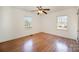 Bright bedroom featuring hardwood floors, a ceiling fan, and ample natural light at 1601 South Point Rd, Belmont, NC 28012