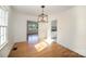 Open dining room with hardwood floors, leading to the kitchen and offering ample natural light at 1601 South Point Rd, Belmont, NC 28012