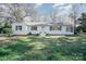 Charming single-story home with white painted brick, black shutters, and well-maintained lawn at 1601 South Point Rd, Belmont, NC 28012