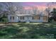 Charming single-story home with white painted brick, black shutters, and well-maintained lawn at 1601 South Point Rd, Belmont, NC 28012