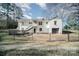 Back exterior of the house with a black chain link fence and a wooden deck at 1601 South Point Rd, Belmont, NC 28012