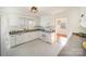 Bright kitchen with white cabinetry, stainless appliances, and decorative flooring at 1601 South Point Rd, Belmont, NC 28012