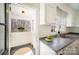 Kitchen with backyard access to a screened-in porch, natural light, and modern features at 1601 South Point Rd, Belmont, NC 28012