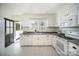 Updated kitchen with white cabinetry, modern appliances, and a stylish patterned floor at 1601 South Point Rd, Belmont, NC 28012
