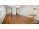 Spacious living room featuring gleaming hardwood floors, neutral paint, and ample natural light at 1601 South Point Rd, Belmont, NC 28012