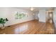 Bright living room featuring gleaming hardwood floors, neutral paint, and ample natural light at 1601 South Point Rd, Belmont, NC 28012