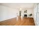 Open living room with gleaming hardwood floors, neutral paint, and a decorative fireplace at 1601 South Point Rd, Belmont, NC 28012