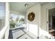 Inviting screened porch with swing, painted brick, and a leafy seasonal wreath at 1601 South Point Rd, Belmont, NC 28012