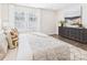 Comfortable bedroom with large windows, dark wood furniture, and plush decor at 1720 Coral Bark Ln # Kh15, Charlotte, NC 28216
