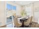 Cozy dining area with a view to the backyard, featuring a modern table set and sliding door at 1720 Coral Bark Ln # Kh15, Charlotte, NC 28216