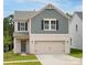 Charming two-story home featuring a brick-and-shingle exterior with a two-car garage at 1720 Coral Bark Ln # Kh15, Charlotte, NC 28216