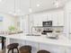 Open kitchen with island seating, stainless steel appliances, and pendant lighting fixtures at 1720 Coral Bark Ln # Kh15, Charlotte, NC 28216
