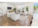 Bright living room featuring modern furniture, hardwood floors, and large windows at 1720 Coral Bark Ln # Kh15, Charlotte, NC 28216