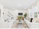Bright living room with white furniture, hardwood floors, and large windows at 1720 Coral Bark Ln # Kh15, Charlotte, NC 28216