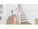 Bright entryway features a staircase with modern railing and wood flooring at 1720 Coral Bark Ln # Kh15, Charlotte, NC 28216