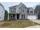 Charming two-story home featuring a stone facade, a two-car garage, and manicured front lawn at 173 Glenn Dr, Mooresville, NC 28115