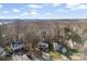 A charming neighborhood is displayed in an aerial shot with picturesque tree lines and lake in the background at 1811 Endeavor Ln, Clover, SC 29710