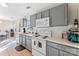 Bright kitchen features gray cabinetry, modern white appliances, and eat-in space at 1811 Endeavor Ln, Clover, SC 29710