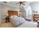 Bright bedroom features a sloped ceiling, ceiling fan, and a natural wood headboard at 1996 Farrow Dr, Rock Hill, SC 29732