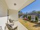 A cozy back porch with seating overlooking a well-maintained yard and neighboring homes, providing a relaxing outdoor space at 2009 White Cypress Ct # Kh13, Charlotte, NC 28216