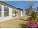 Charming backyard with a covered patio, seating, landscaped lawn, and bright pink flowers at 2009 White Cypress Ct # Kh13, Charlotte, NC 28216