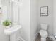 Contemporary powder room featuring a pedestal sink, toilet, and modern decor at 2009 White Cypress Ct # Kh13, Charlotte, NC 28216