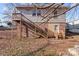 Back of house with backyard, deck with stair access and brick foundation at 208 W Lafayette St, Salisbury, NC 28144