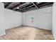 Spacious unfinished basement features exposed ceiling, painted walls and wood plank floors at 208 W Lafayette St, Salisbury, NC 28144