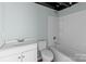 Bathroom boasts a modern vanity, toilet, and tub/shower combination at 208 W Lafayette St, Salisbury, NC 28144