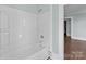 Bright bathroom featuring a tiled shower and tub combination at 208 W Lafayette St, Salisbury, NC 28144