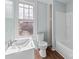 Cozy bathroom featuring a vanity, toilet, and tub at 208 W Lafayette St, Salisbury, NC 28144