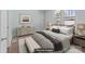 Staged bedroom featuring a comfortable bed, stylish dresser, and a bench for added appeal at 208 W Lafayette St, Salisbury, NC 28144
