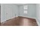 Cozy bedroom featuring hardwood floors, white trim, and natural light at 208 W Lafayette St, Salisbury, NC 28144