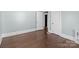 Bedroom with wood floors, light blue walls, and an open white door at 208 W Lafayette St, Salisbury, NC 28144