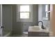 Cozy bathroom featuring a shower-tub combo, single sink vanity, and a bright window at 216 Park Ridge Rd, Albemarle, NC 28001