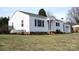 Side view of a cozy home featuring white siding and a well-maintained lawn, inviting comfort and style at 216 Park Ridge Rd, Albemarle, NC 28001