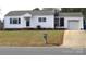 Charming single-story home with a tidy front lawn and attached garage, showcasing curb appeal at 216 Park Ridge Rd, Albemarle, NC 28001
