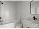 Bathroom featuring white subway tiles, a tub, and stylish vanity at 236 Victoria Ave, Charlotte, NC 28202