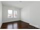A bright empty bedroom with hardwood floors and natural light from multiple windows at 236 Victoria Ave, Charlotte, NC 28202
