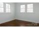 A bright empty bedroom with hardwood floors and natural light from multiple windows at 236 Victoria Ave, Charlotte, NC 28202