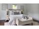 Cozy bedroom featuring two windows, a comfortable bed, and stylish decor at 236 Victoria Ave, Charlotte, NC 28202