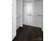 A well-organized walk-in closet with custom shelving and dark wood floors at 236 Victoria Ave, Charlotte, NC 28202