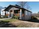 Charming craftsman home featuring a welcoming front porch with wooden railings, and lush landscaping at 236 Victoria Ave, Charlotte, NC 28202