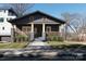 Charming gray home with a covered front porch, wood railings, and manicured landscaping at 236 Victoria Ave, Charlotte, NC 28202