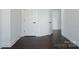 Hallway featuring hardwood floors and a series of doors leading to different rooms at 236 Victoria Ave, Charlotte, NC 28202