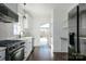 Modern kitchen featuring stainless steel appliances, white cabinetry, and a view of the backyard at 236 Victoria Ave, Charlotte, NC 28202